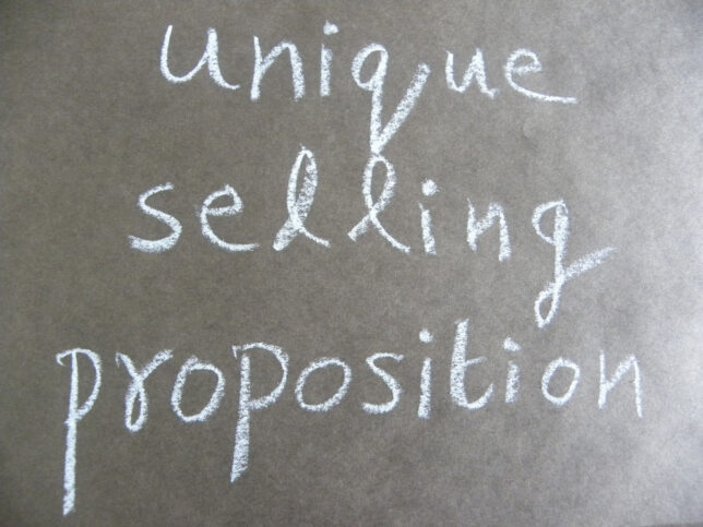 a hand written sign , unique sellig proposition on a blackboard
